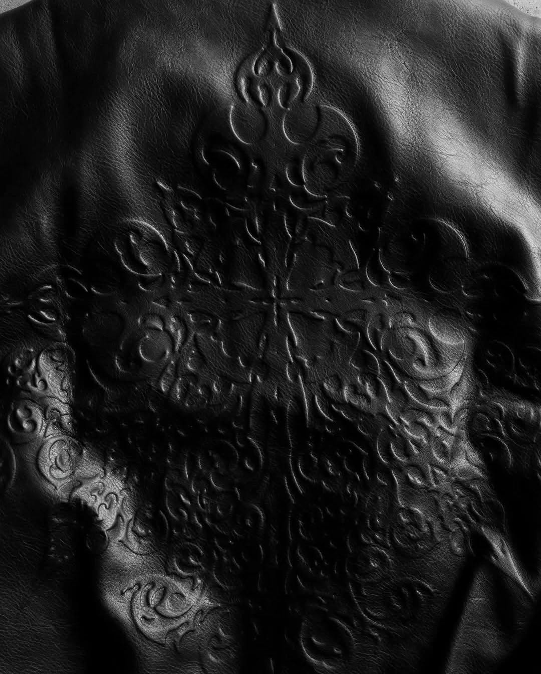 monochrome darkwear outfit featuring a statement embossed leather bomber jacket