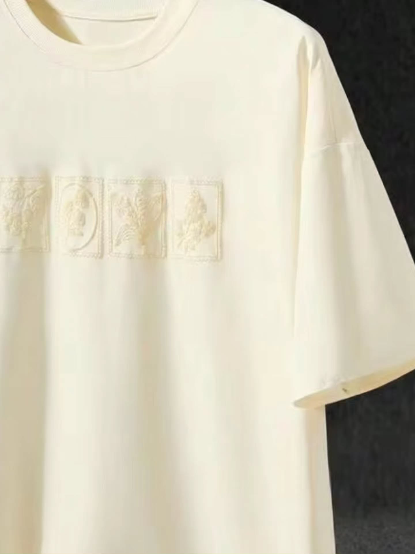 off-white / cream short-sleeved t-shirt with a subtle