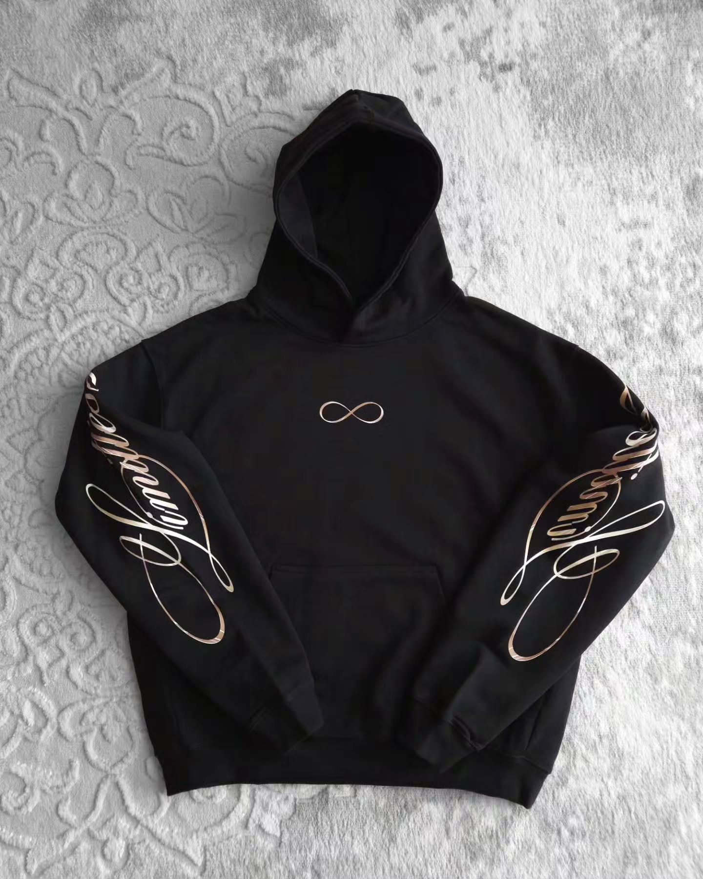 black pullover hoodie featuring an anime-inspired graphic design with dark fantasy