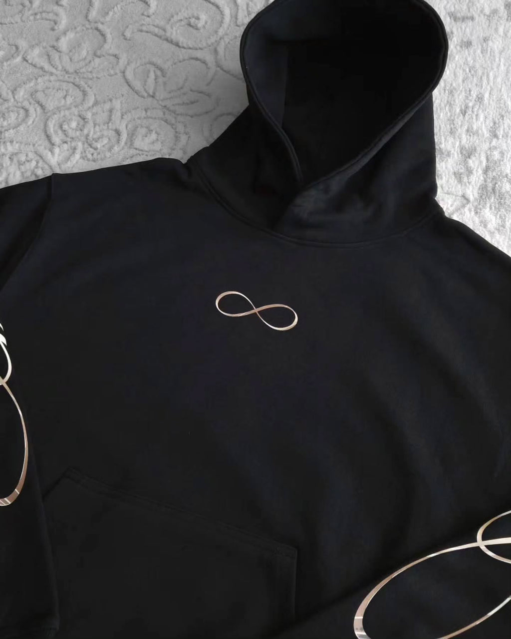 black pullover hoodie featuring an anime-inspired graphic design with dark fantasy