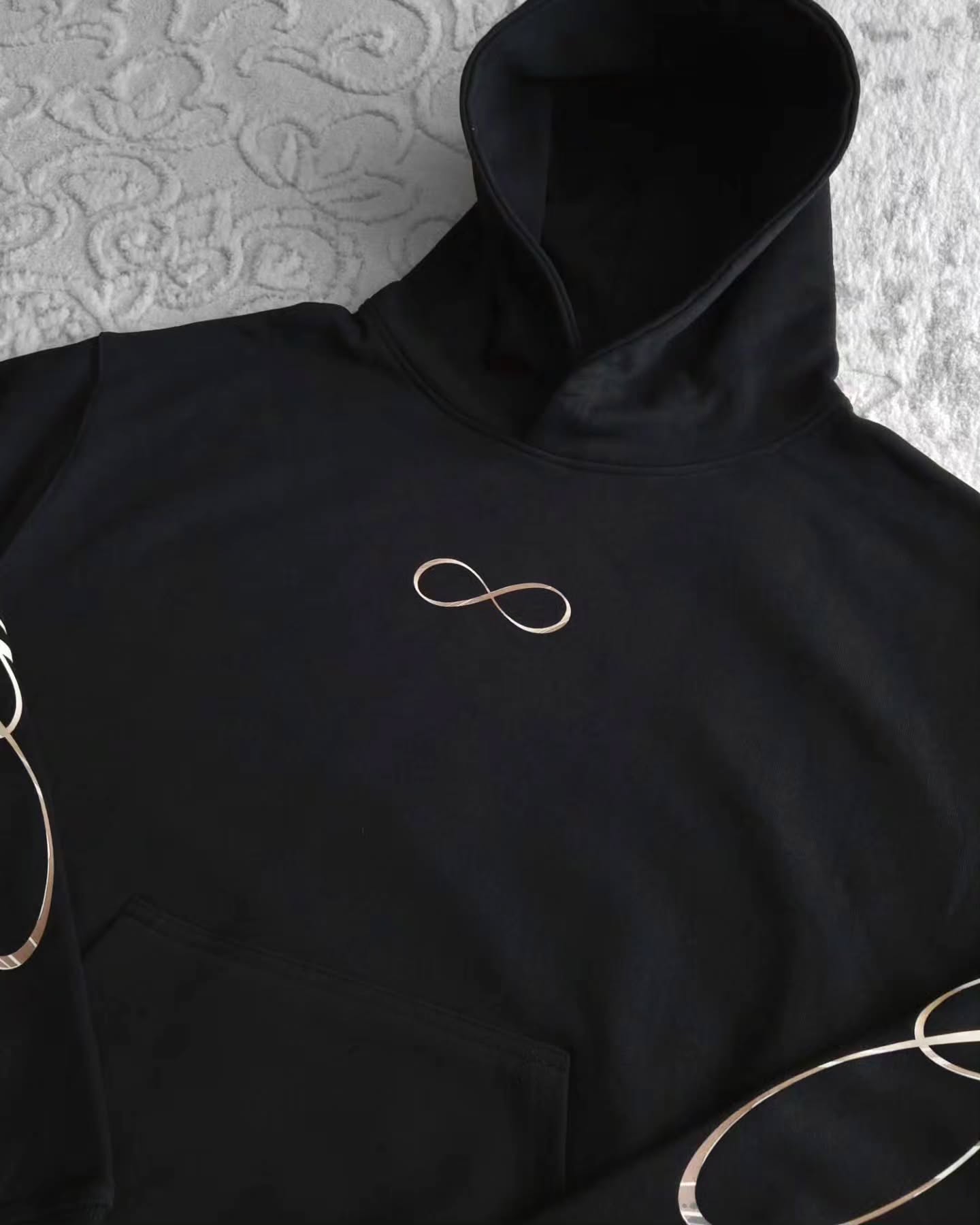 black pullover hoodie featuring an anime-inspired graphic design with dark fantasy