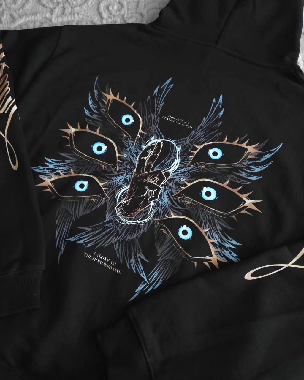 black pullover hoodie featuring an anime-inspired graphic design with dark fantasy