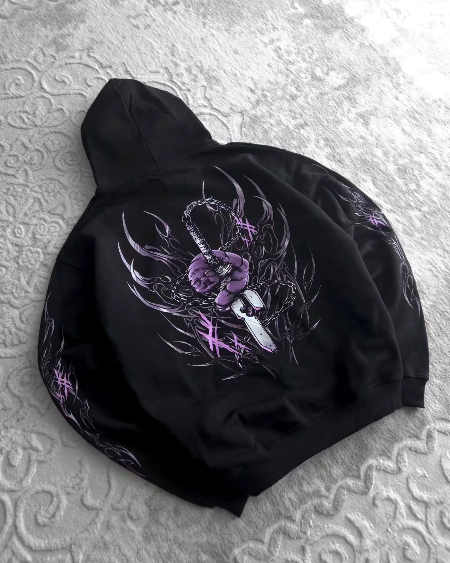 black pullover hoodie featuring an anime-inspired