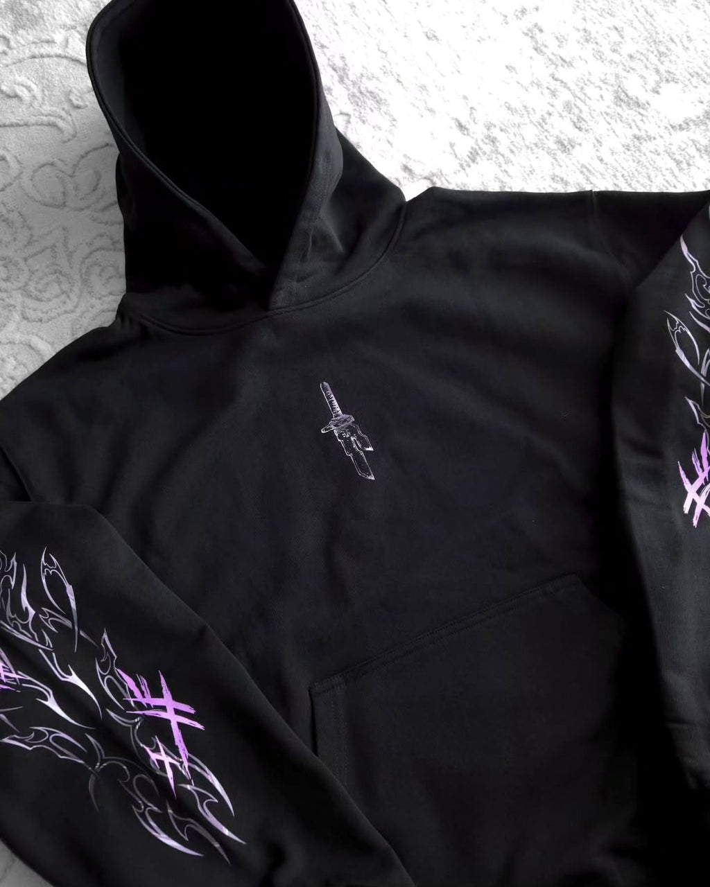 black pullover hoodie featuring an anime-inspired