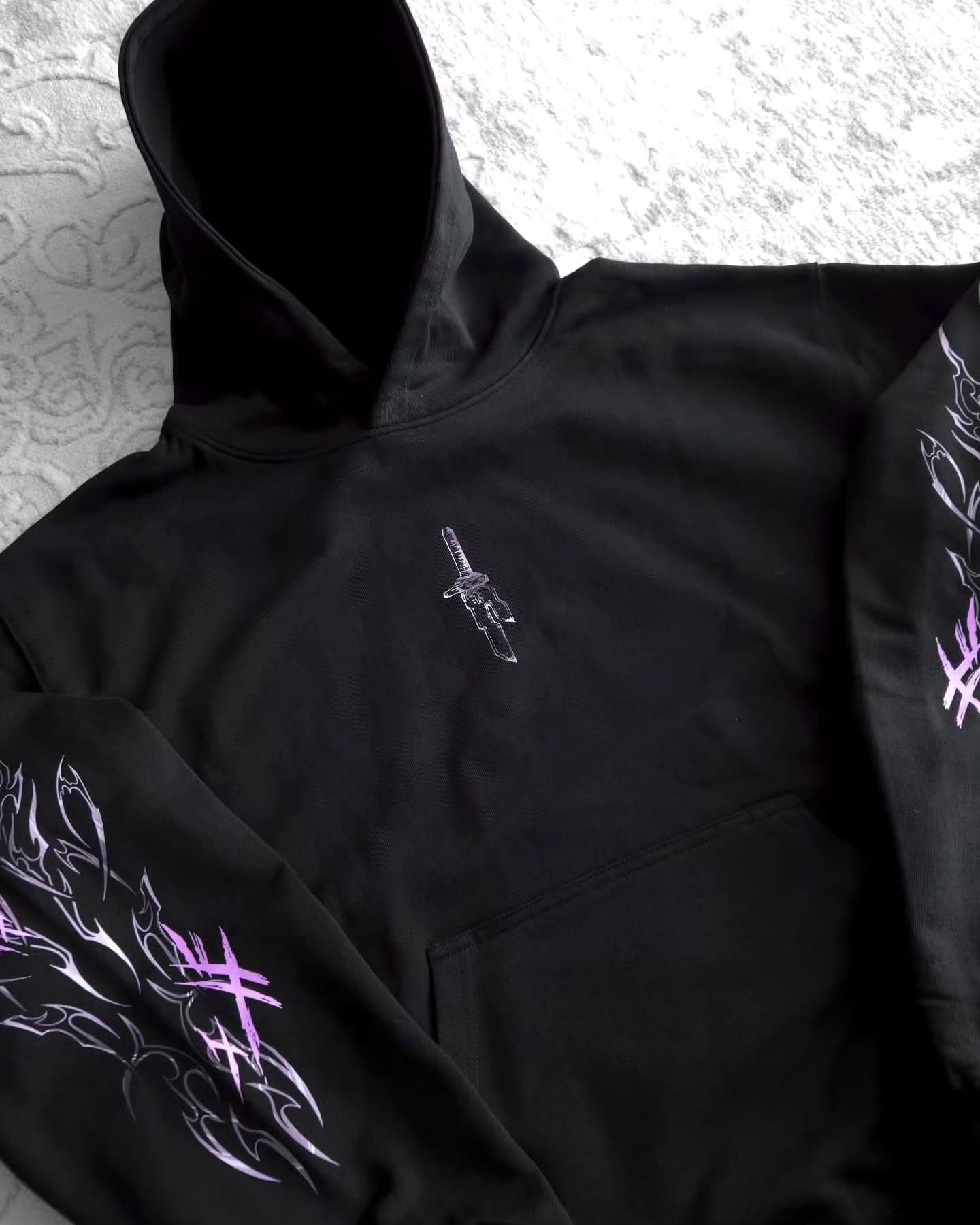 black pullover hoodie featuring an anime-inspired