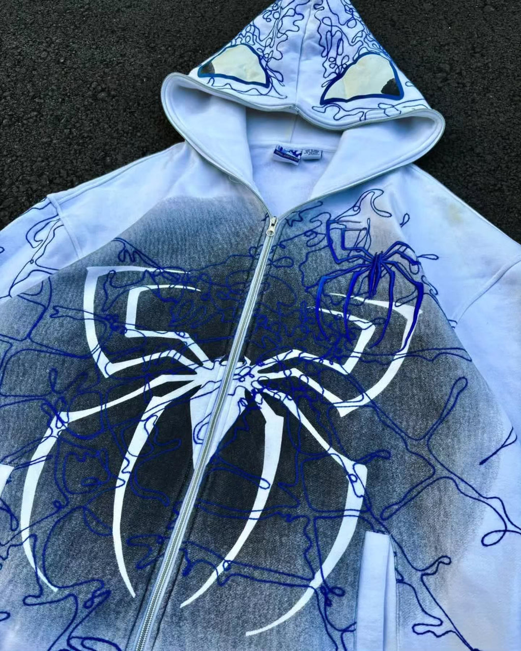 bright white full-zip hoodie themed heavily around Spider-Man