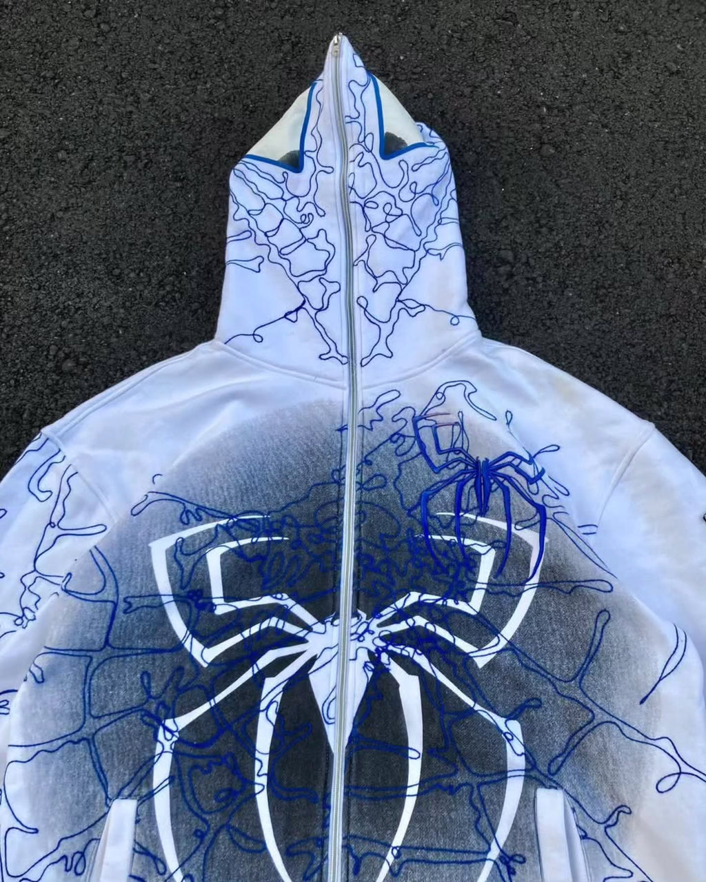 bright white full-zip hoodie themed heavily around Spider-Man