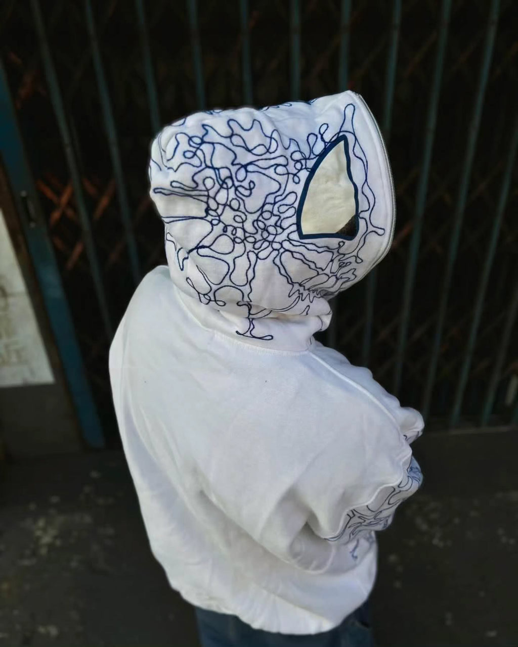 bright white full-zip hoodie themed heavily around Spider-Man