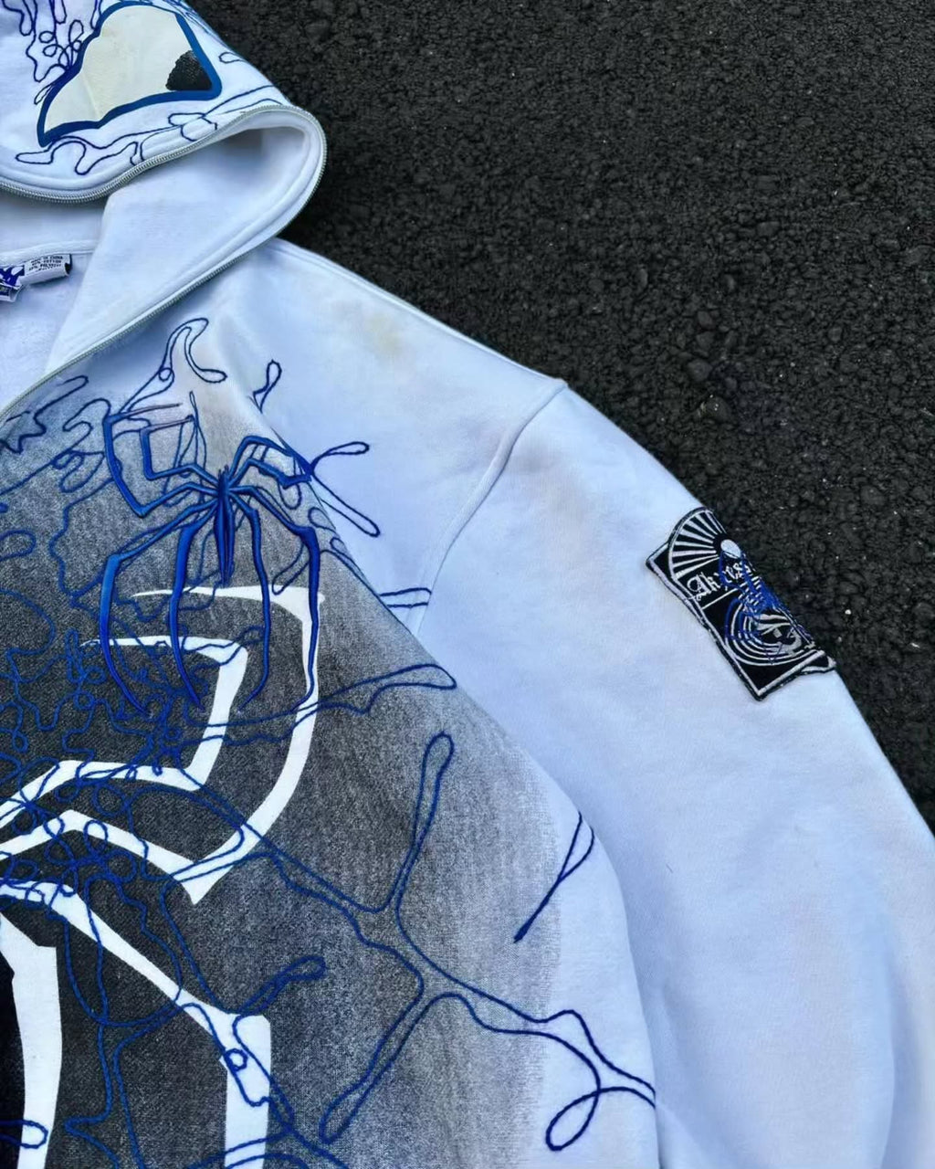 bright white full-zip hoodie themed heavily around Spider-Man