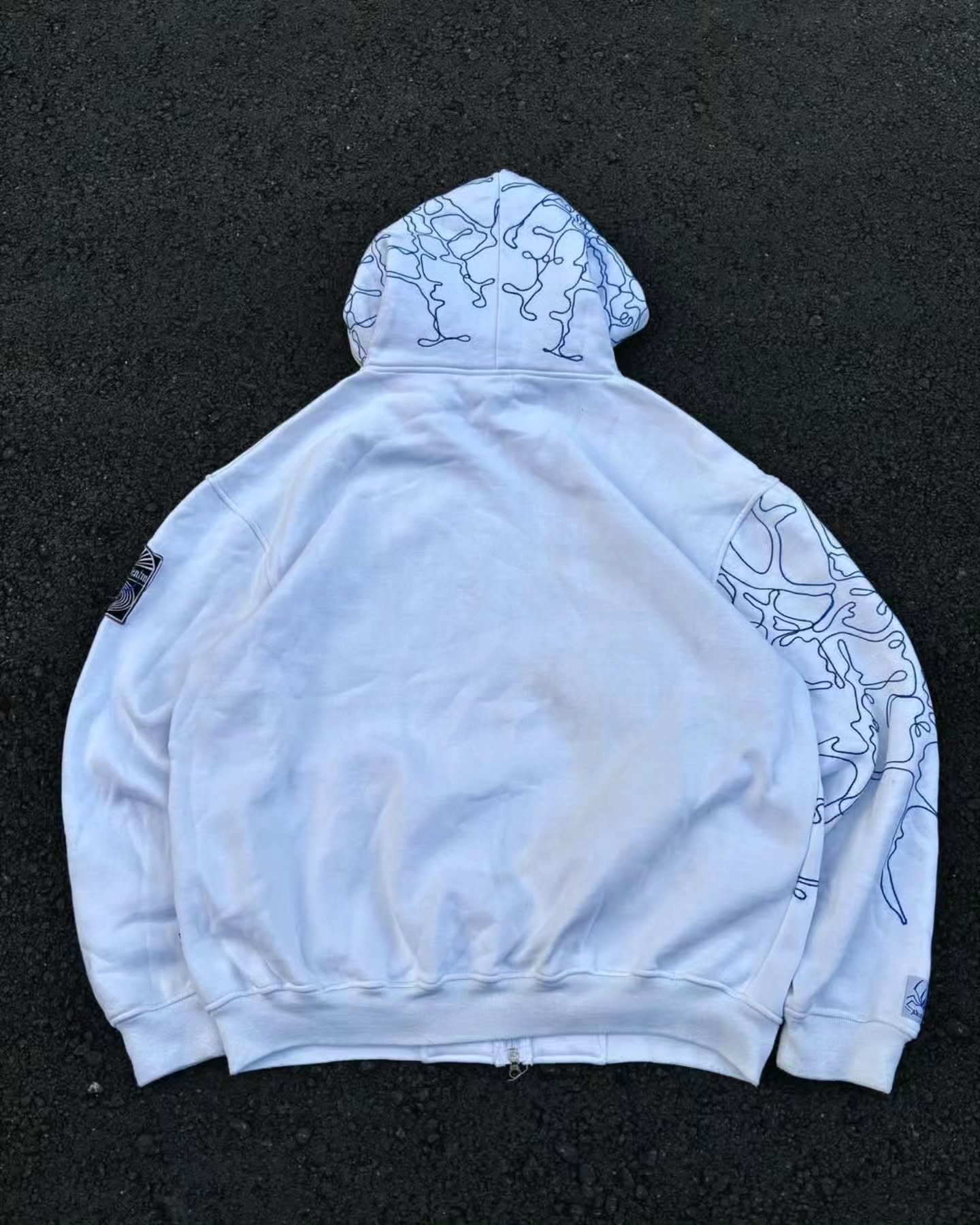 bright white full-zip hoodie themed heavily around Spider-Man