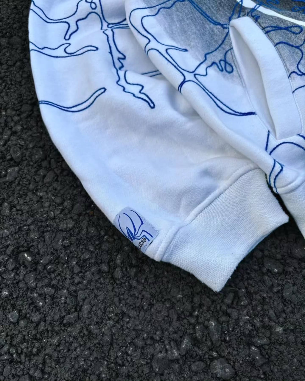 bright white full-zip hoodie themed heavily around Spider-Man