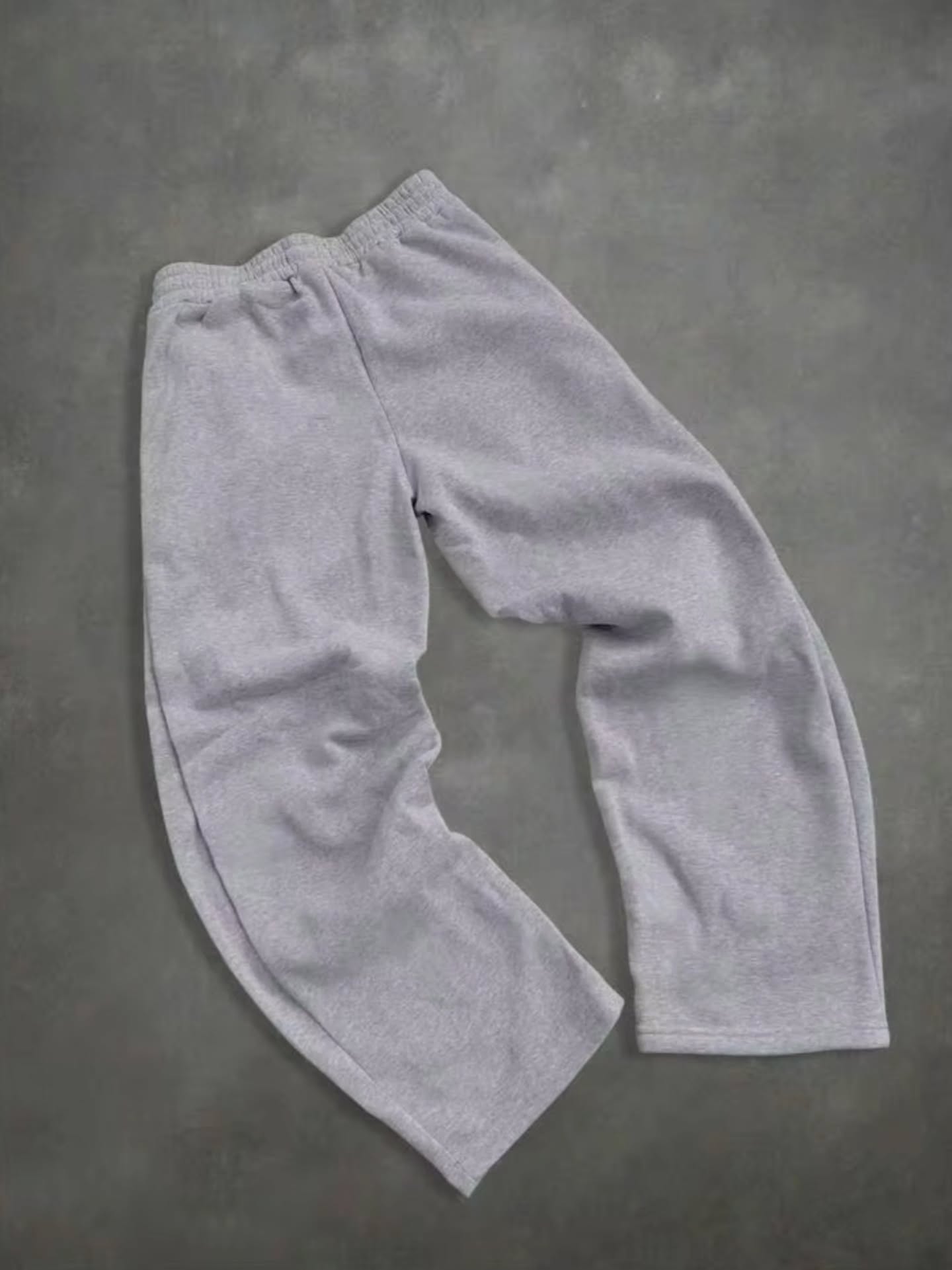 boxy, oversized streetwear outfit pairing a cropped acid-washed zip hoodie with wide-leg graphic sweatpants for a relaxed, Y2K-inspired silhouette.