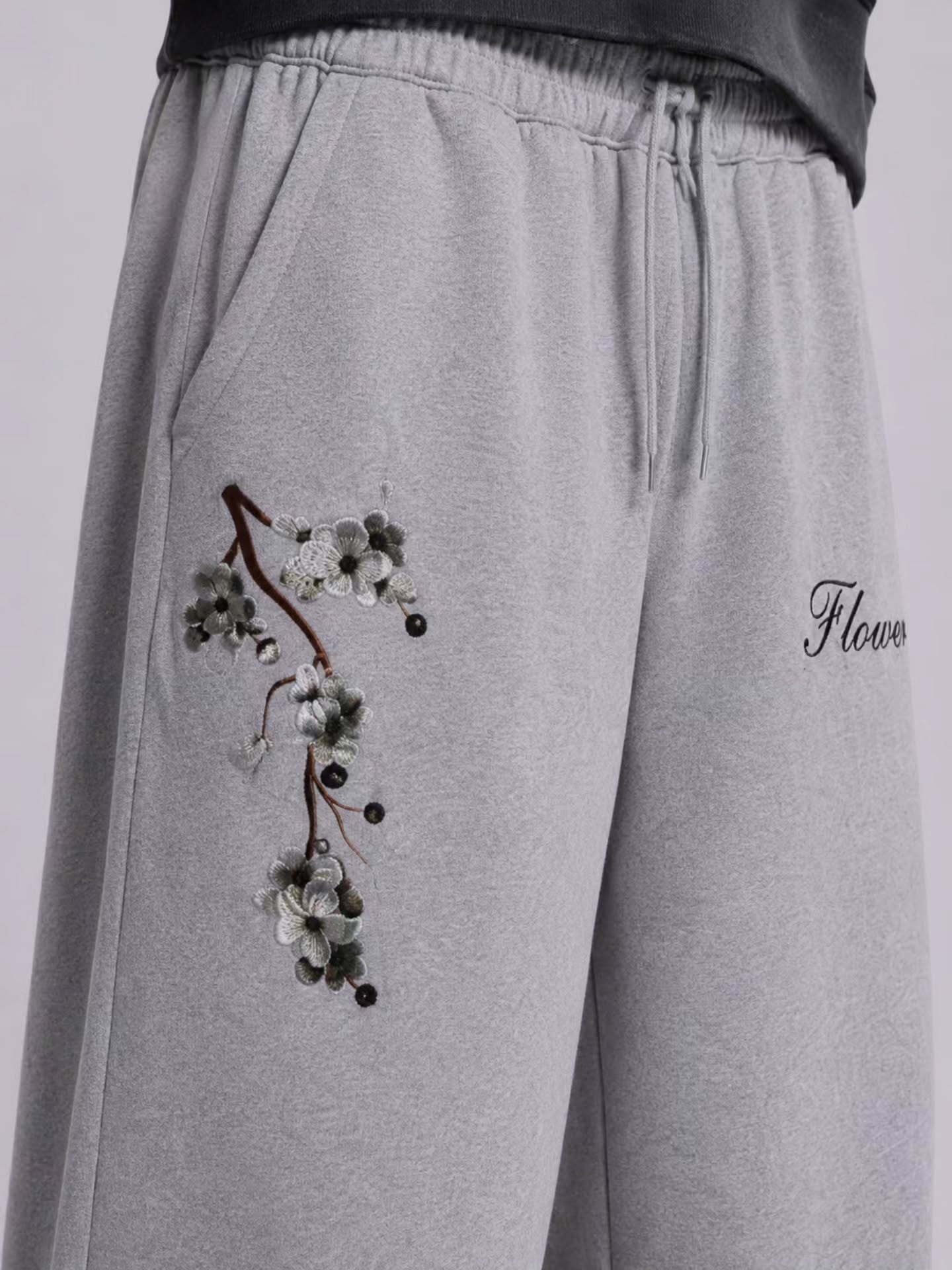 boxy, oversized streetwear outfit pairing a cropped acid-washed zip hoodie with wide-leg graphic sweatpants for a relaxed, Y2K-inspired silhouette.