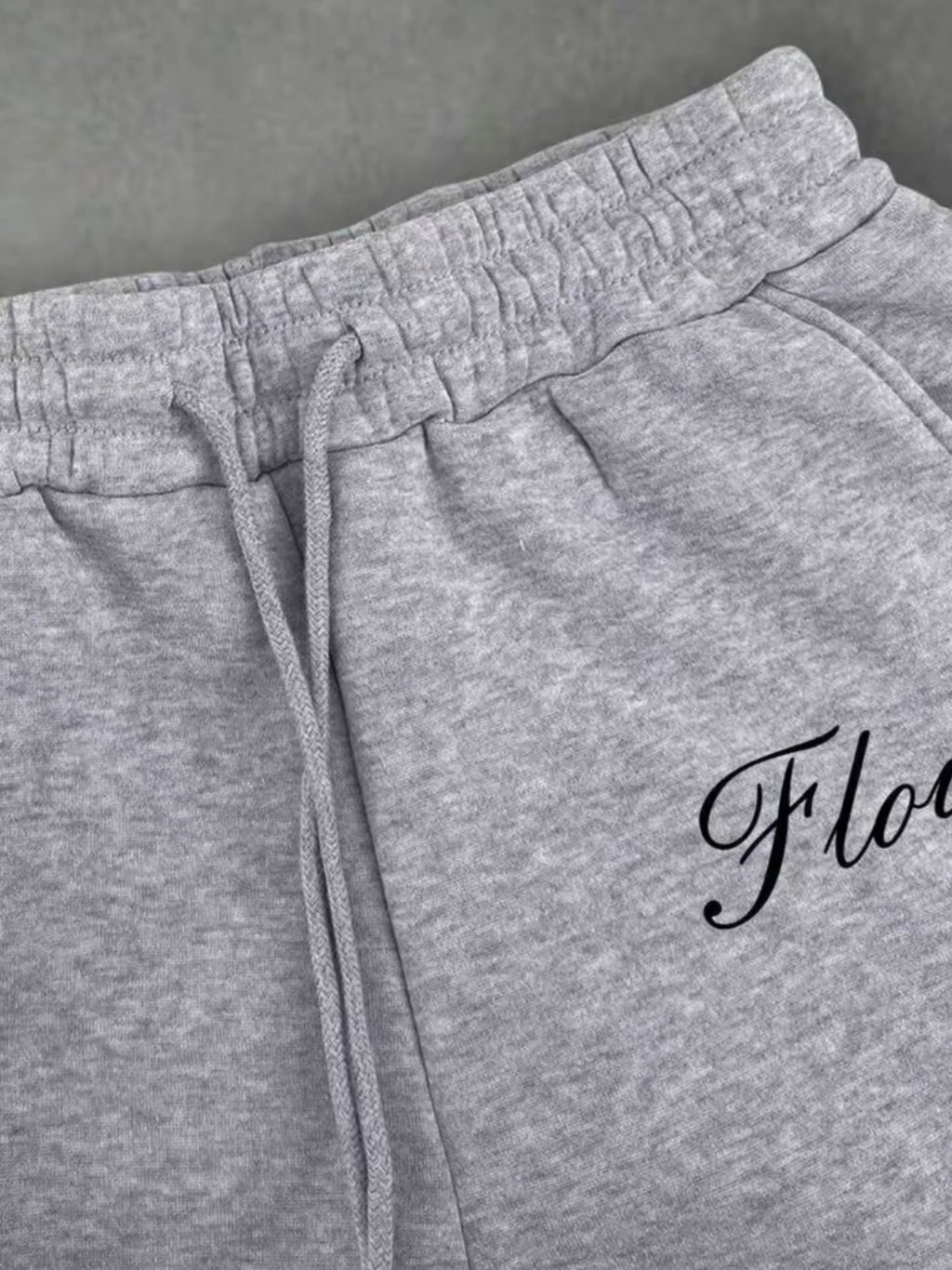 boxy, oversized streetwear outfit pairing a cropped acid-washed zip hoodie with wide-leg graphic sweatpants for a relaxed, Y2K-inspired silhouette.