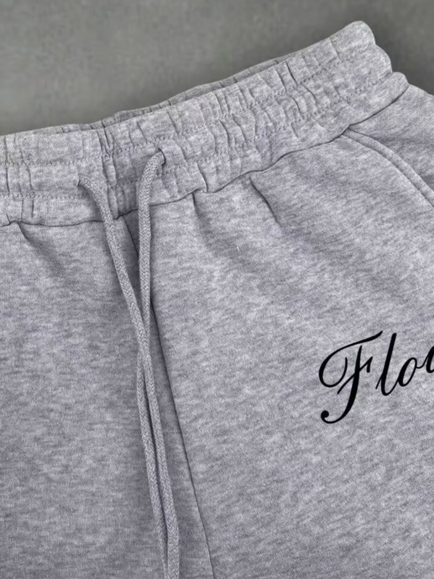 boxy, oversized streetwear outfit pairing a cropped acid-washed zip hoodie with wide-leg graphic sweatpants for a relaxed, Y2K-inspired silhouette.